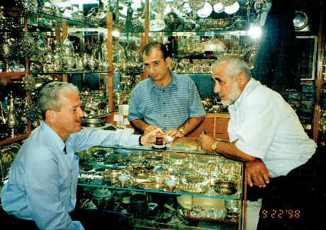 Reggie at the Grand Bazaar reminiscing with his uncle (right), who trained him in the art of jewelry making.